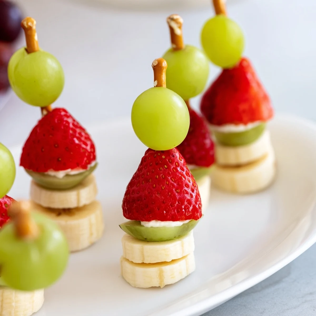 These easy Elf Hat Strawberry Skewers are a fun, healthy snack of fresh fruit on pretzel sticks.