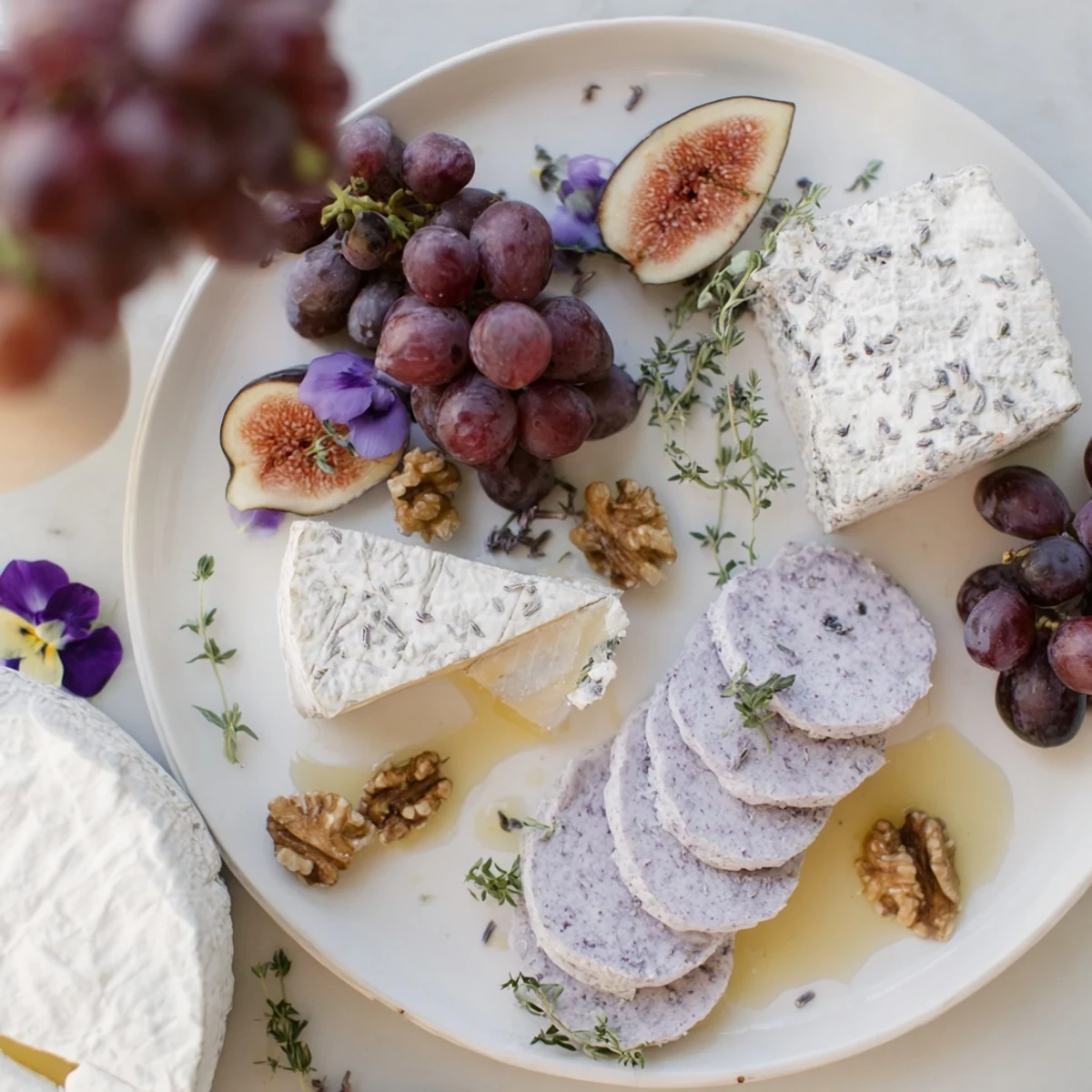 Elegant "Lavender Haze" cheese platter featuring lavender cheese, brie, and figs, ready to be enjoyed.