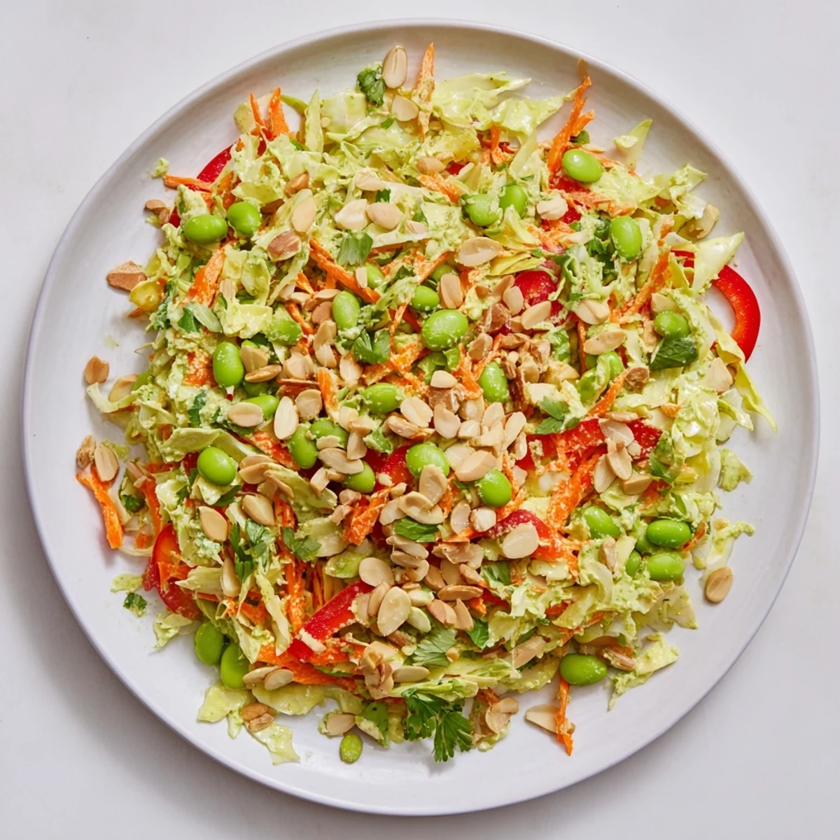 Vibrant Crunchy Cabbage and Edamame Salad with colorful veggies and a creamy green dressing.
