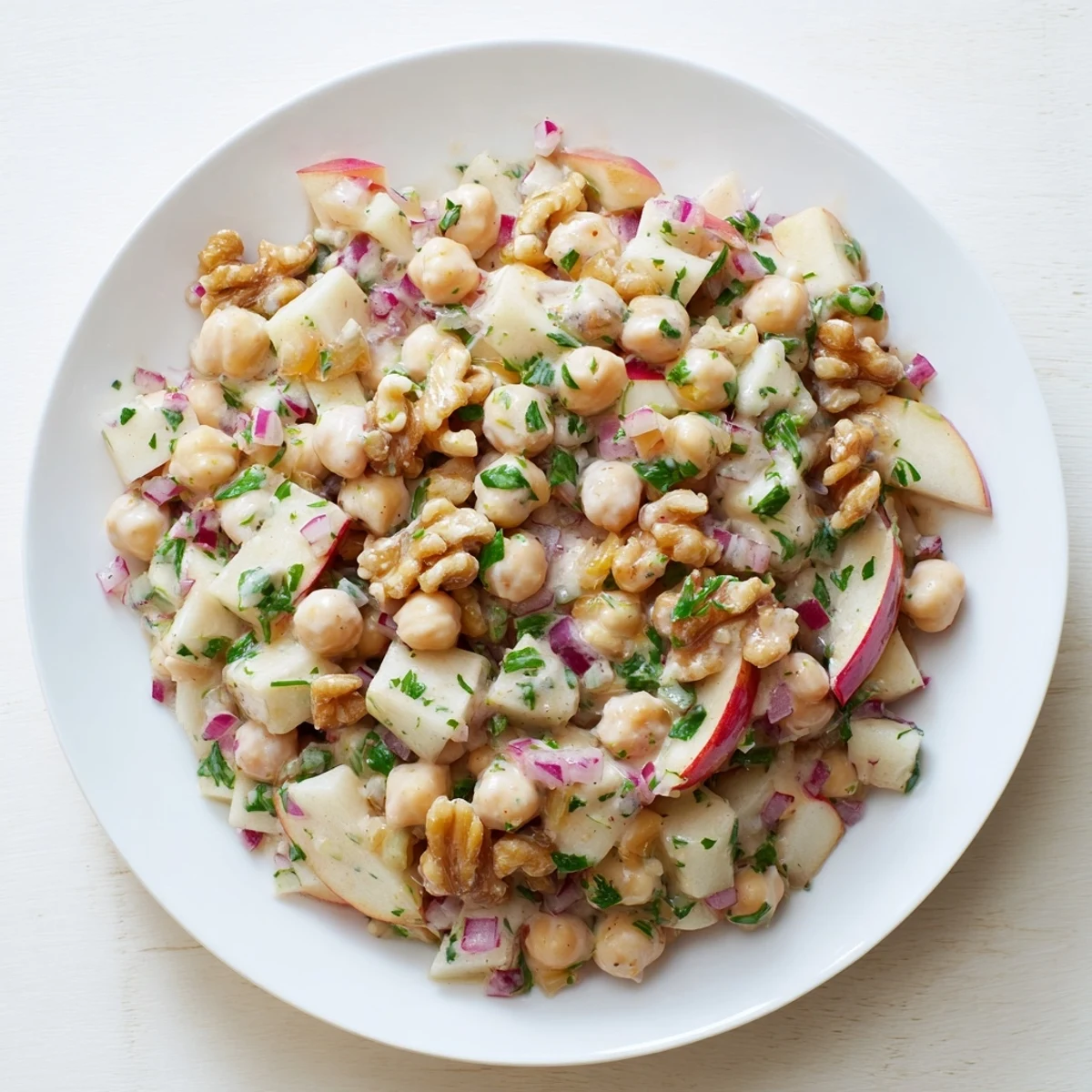 Vibrant Fall Harvest Apple and Chickpea Salad brimming with crisp apples and a creamy dressing, ready to enjoy.
