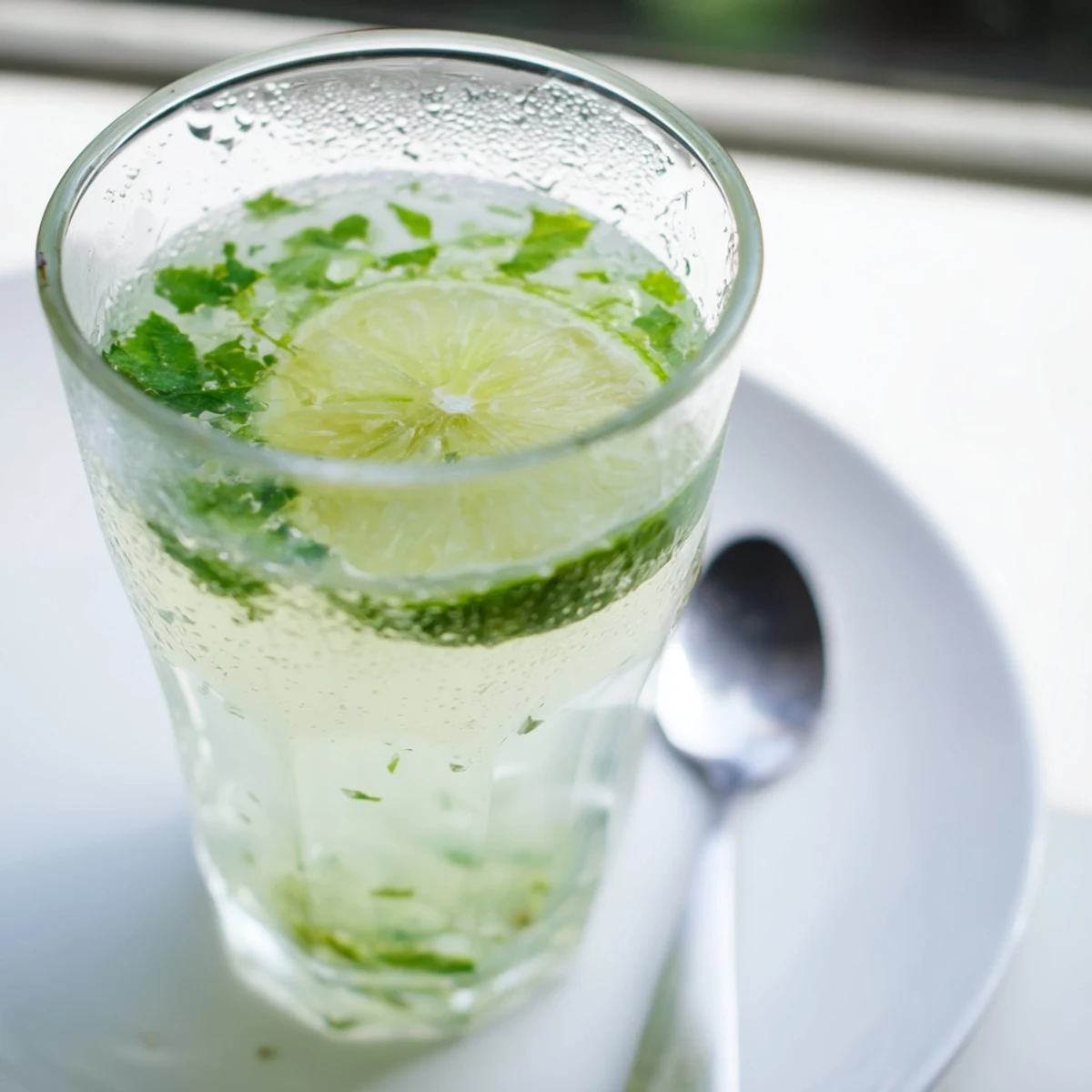 Refreshing chilled Mint Lime Agua Fresca, garnished with lime, ready to quench your thirst.