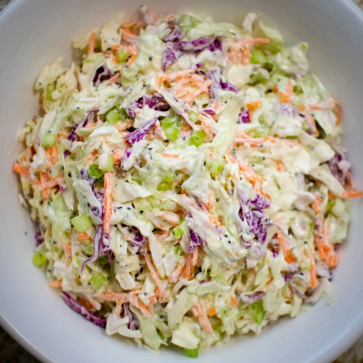 Quick Coleslaw Salad with Creamy Dressing, featuring shredded cabbage and carrots, ready to serve as a side.