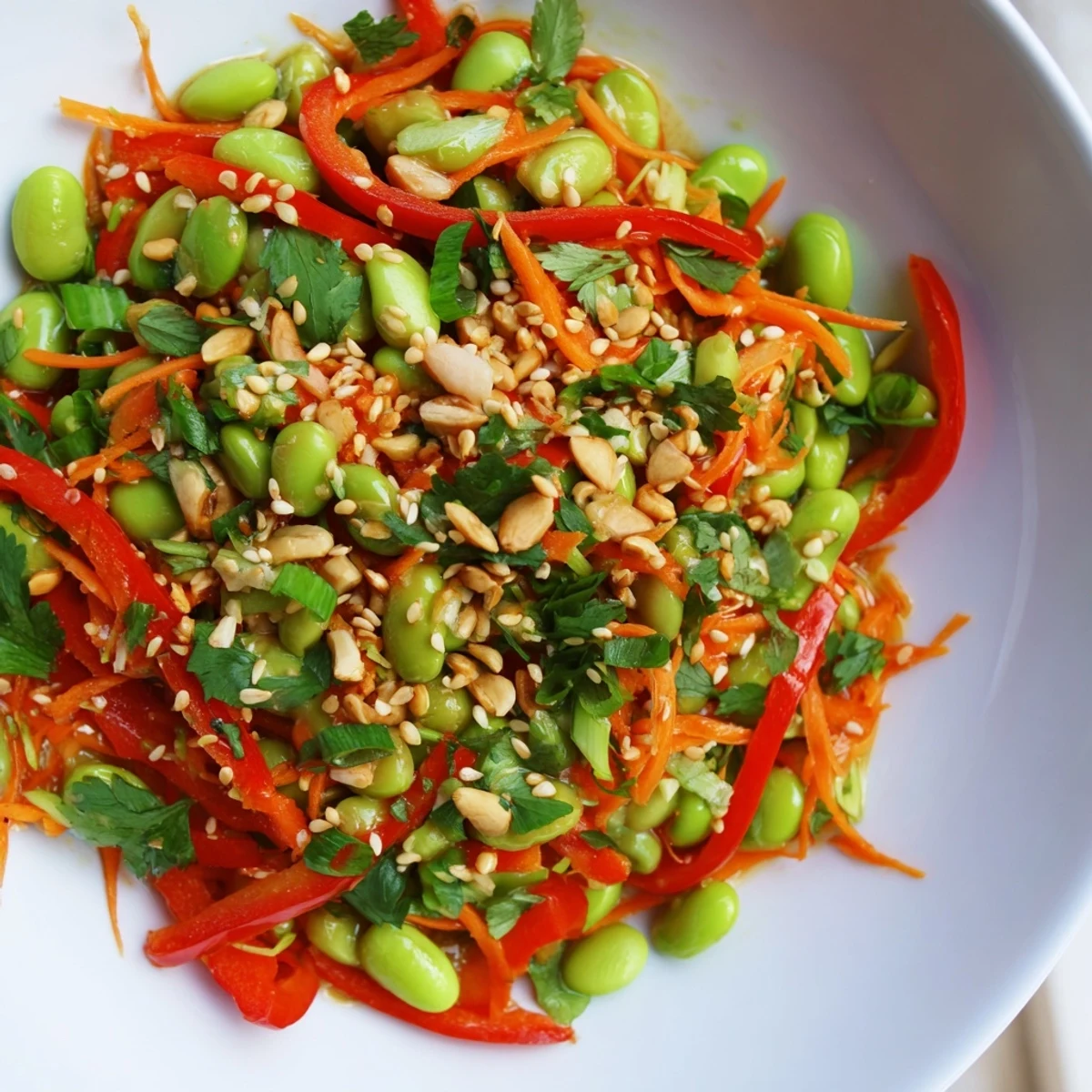 Steaming Asian edamame salad with vibrant veggies and a zesty sesame-ginger dressing, ready to enjoy.