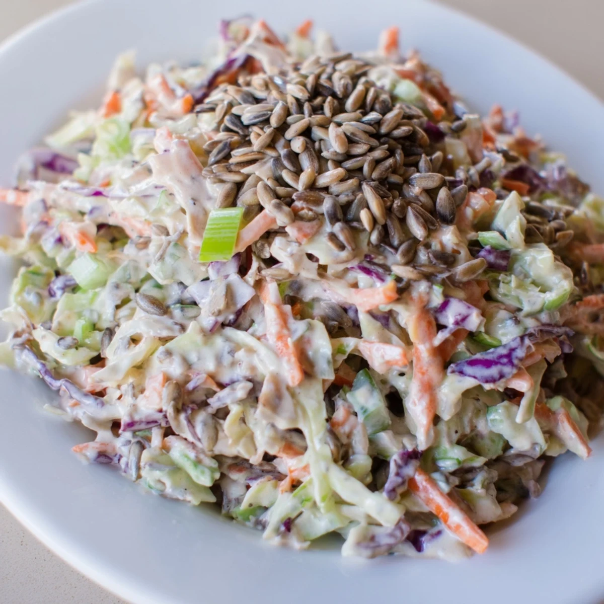 This refreshing crunchy coleslaw salad features a tangy dressing and colorful veggies, perfect for a side dish.