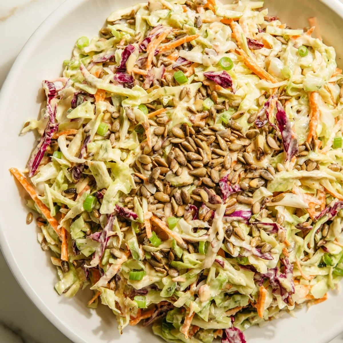 Showcasing the crisp textures of crunchy coleslaw salad, tossed in a creamy dressing ready to enjoy.