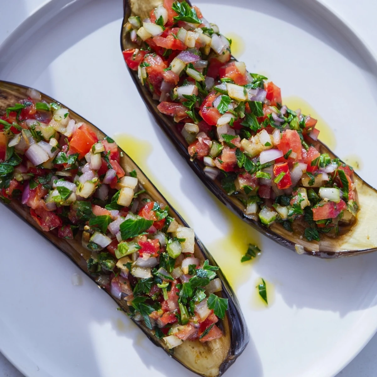 Golden, glistening Imam Bayildi showcasing tender eggplant with a rich, flavorful tomato filling inside.