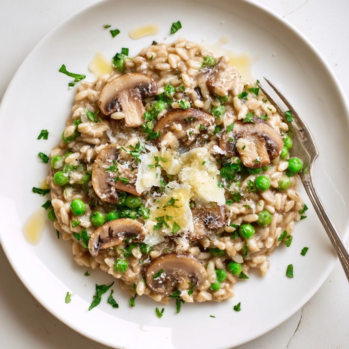 A comforting bowl of Orzo Mushroom Risotto-Style served with a glass of white wine, highlighting its rich, cheesy texture.