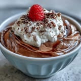 Silky cottage cheese chocolate mousse garnished with shaved dark chocolate, offering a rich, protein-packed treat in elegant serving glasses.