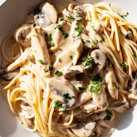 Creamy Mushroom Chicken Spaghettini with tender chicken and velvety sauce, garnished with fresh parsley.