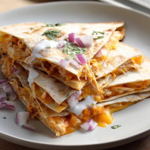 Melting cheese and tender buffalo chicken filling a crispy and delicious quesadilla.