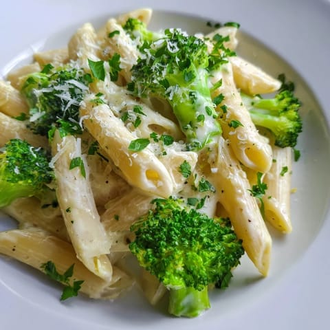 A close-up of vibrant cream cheese garlic pasta, showcasing perfectly cooked pasta and creamy sauce.