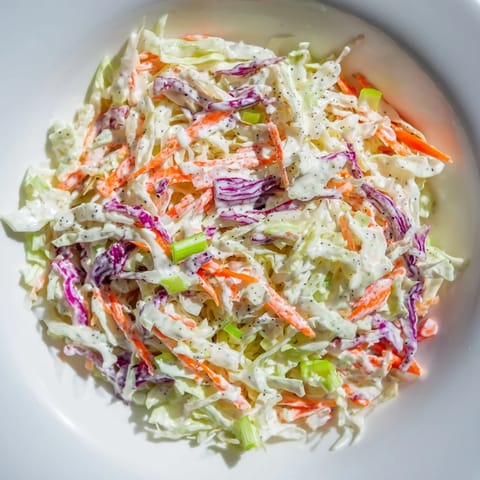 This is a delicious Quick Coleslaw Salad with Creamy Dressing. See the vibrant colors of the freshly chopped vegetables.