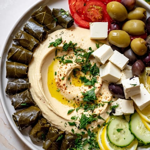 Close-up of a generously arranged Turkish meze platter, highlighting fresh olives alongside various cheeses.