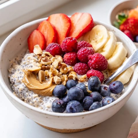 Spoon into creamy Overnight Oats With Chia Seeds, layered with strawberries, chopped walnuts, and a hint of vanilla for breakfast.