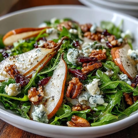 Fresh arugula and sliced ripe pears topped with crumbled blue cheese and toasted walnuts in the Arugula and Pear Bowl.