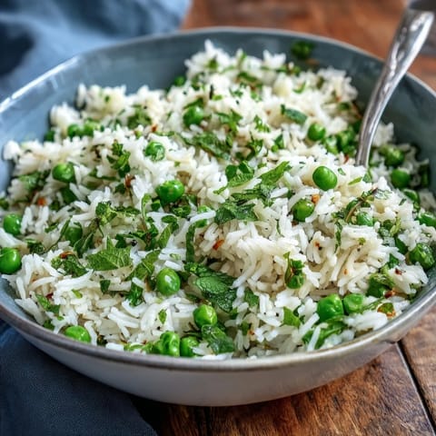 1. Spring Pea and Mint Rice Pilaf with vibrant green peas and fresh mint, served in a white bowl, garnished with lemon wedges.  