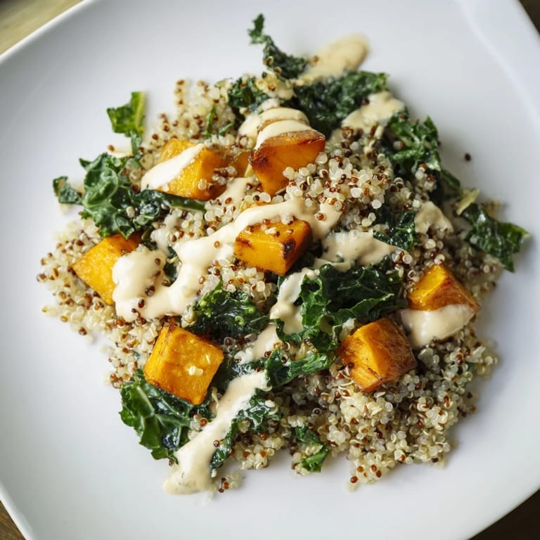 A flavorful Light Coastal Bowl with roasted sweet potatoes, fresh kale, and a creamy lemon-tahini dressing; perfect lunch.