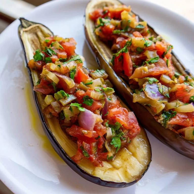 A close-up shot of Imam Bayildi, highlighting the softened eggplant and savory vegetable components, ready to serve.